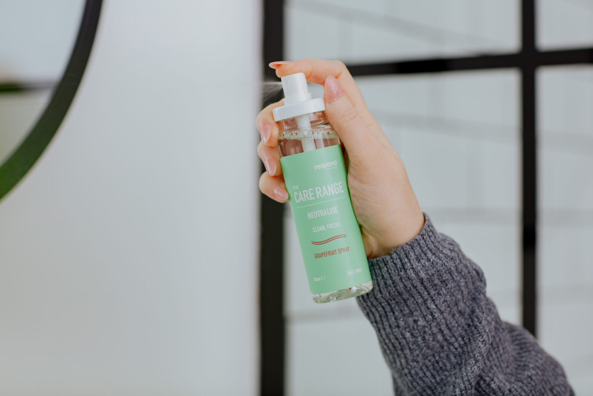 A user sprays our NEUTRALISE neutralising odour sprays in the scent grapefruit into the bathroom.
