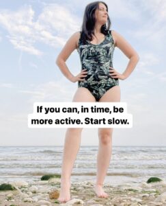 Amy wearing a swimsuit on the beach, showcasing how you can still be active with a stoma bag.